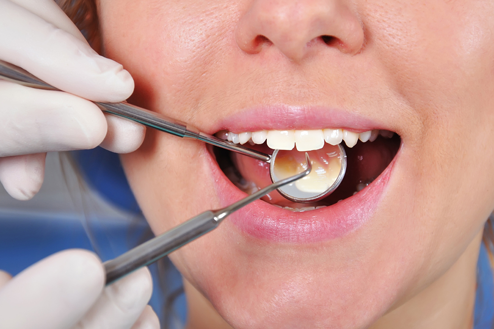 Dentist in Whitby examining urgent oral health warning signs at Birch Dental